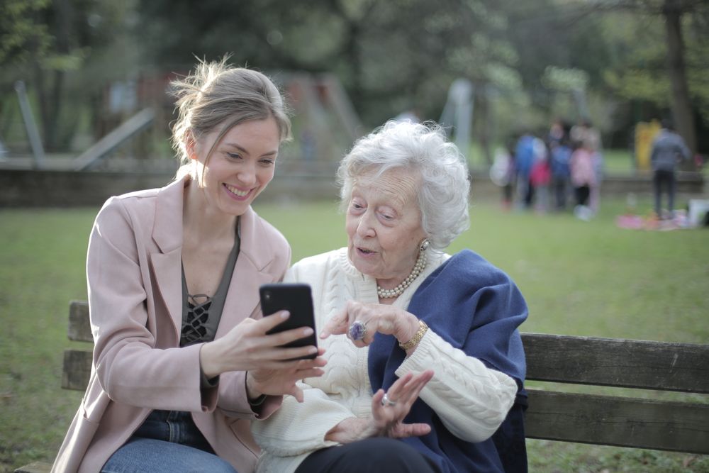 A mother and daughter learning to use a smartphone together